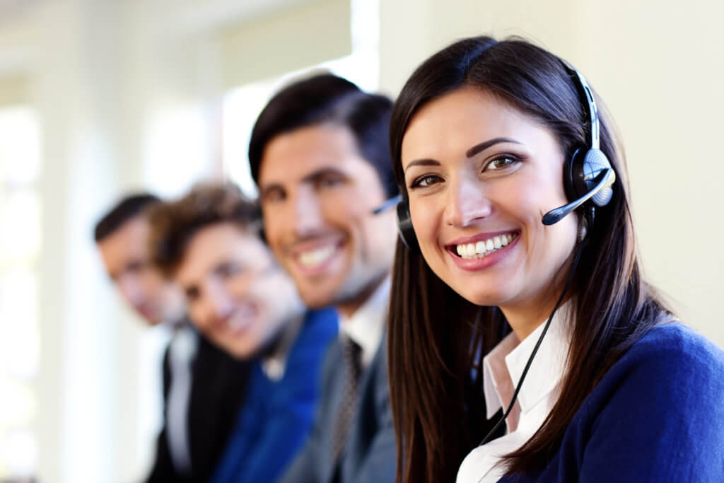 Smiling professionals in headsets