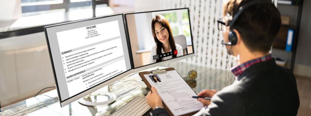 Man conducting online job interview with female candidate