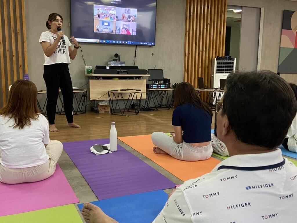 Woman presenting at office yoga sales conference