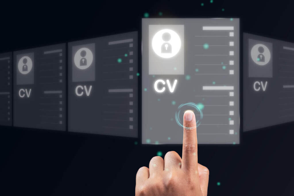Hand with finger pointing on a screen showing a CV. The use of AI in recruitment concept.