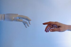 Human and robot reaching out to each other