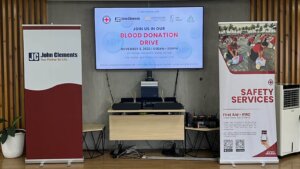 blood donation drive stage with banners and TV in the middle