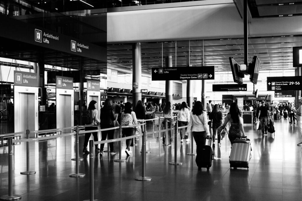 black and white photo of people on airport