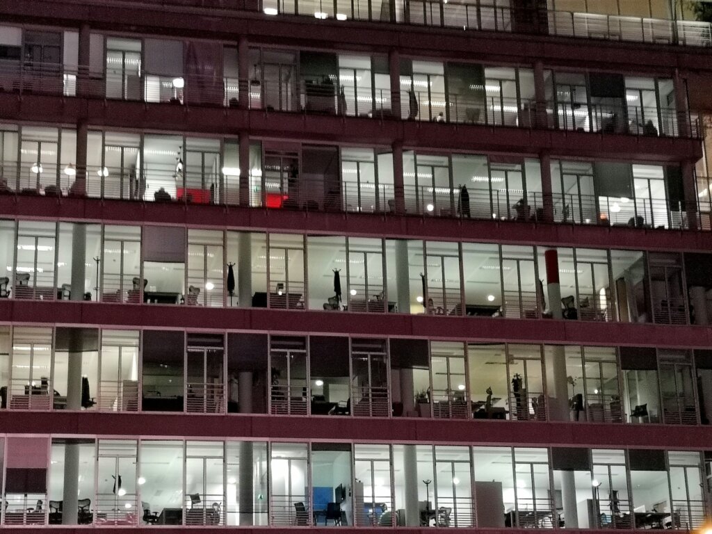windows of an office building lit up at night