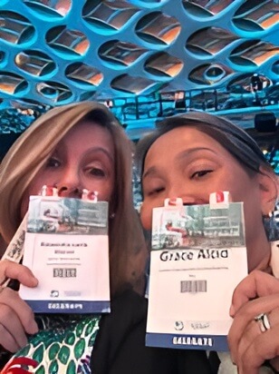 two women showing their event ID passes
