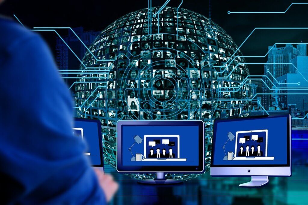 illutration of computer monitors with a globe people's images in the background